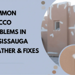 A stucco house exterior with visible repair patches